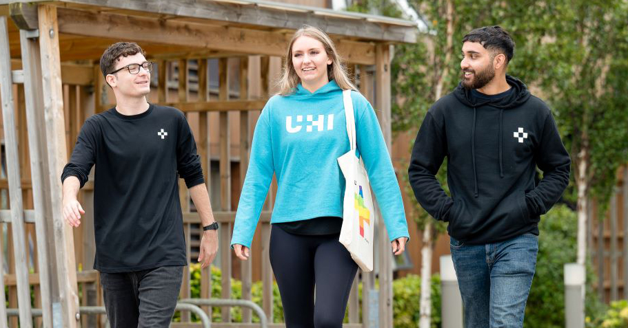 Three people walking while talking Three people walking while talking